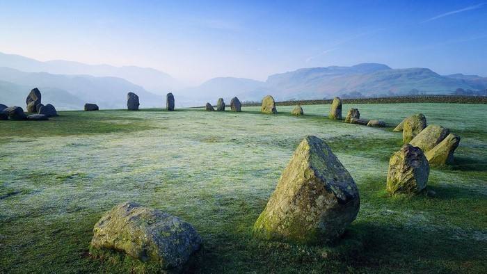 Stone circle on a frosty field with mountains