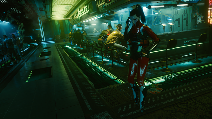 Woman in red suit at a bar in Cyberpunk 2077