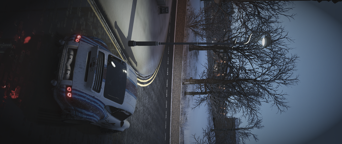 White and blue rally car on a wet road at night