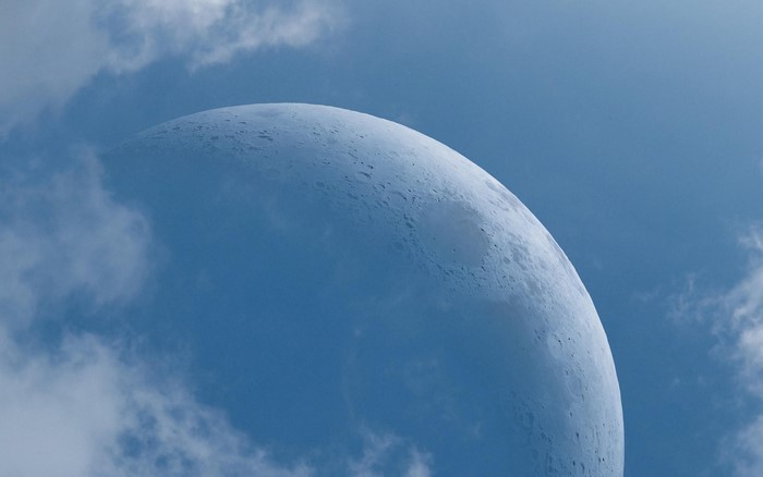 The Moon partially obscured by clouds