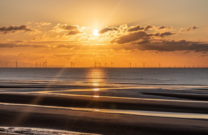 4K sunset over offshore wind farm near Liverpool, England