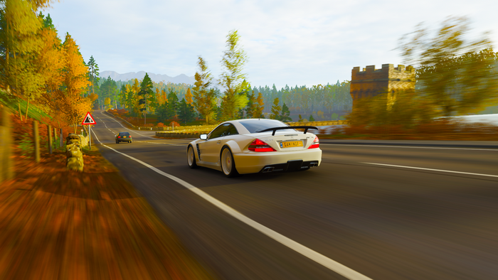 Mercedes-Benz SL65 AMG driving on a road in fall
