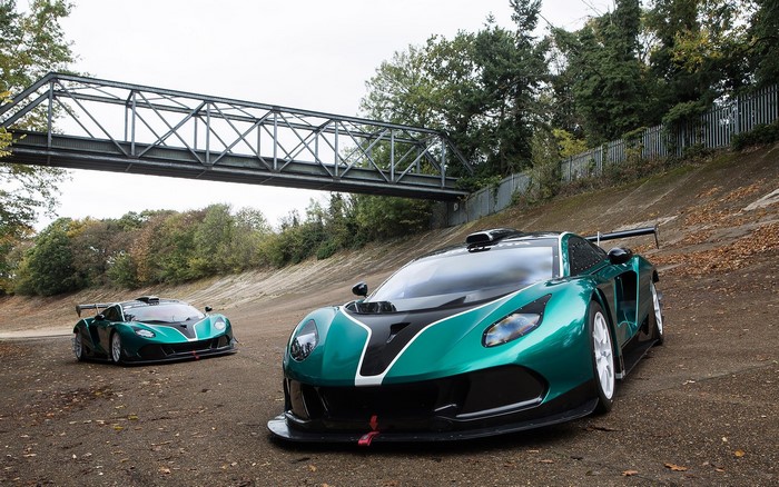 Two Arrinera Hussarya GT race cars on a banked turn