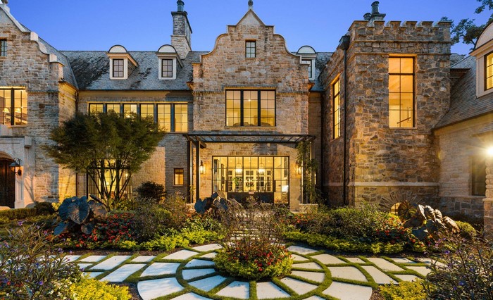 Stone mansion with formal garden and circular pathway