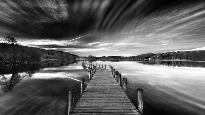 Wooden pier on a lake with dramatic clouds