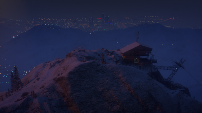 Mount Chiliad ski resort at night with city lights in distance