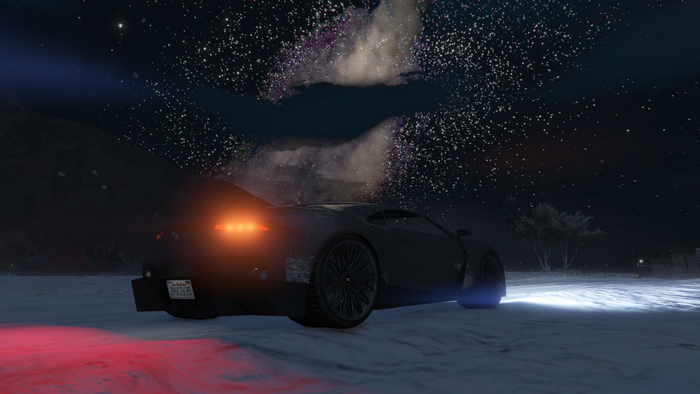 Lamborghini in snowy landscape under starry night sky