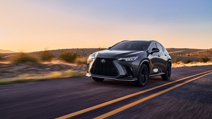 2022 Lexus NX F Sport driving on a road at sunset