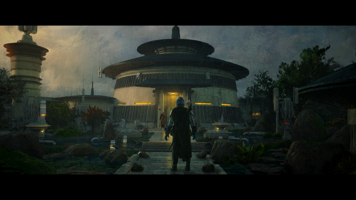 The Mandalorian in front of a building