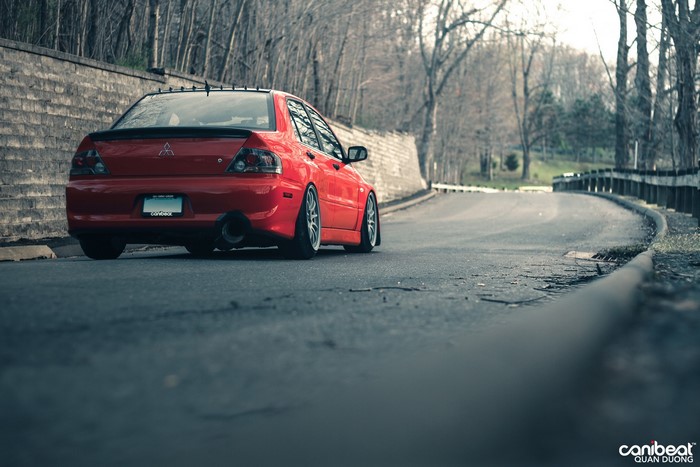 Red Mitsubishi Lancer Evolution VIII on a Road