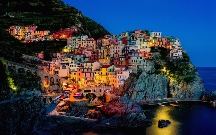 Colorful village on a cliffside at night in Cinque Terre, Italy