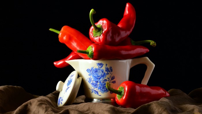 Red chili peppers in a ceramic pitcher
