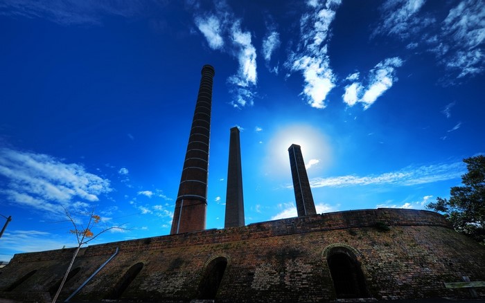 Brick kilns and chimneys in Sydney Park under a blue sky