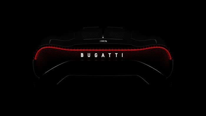 Bugatti car with red taillights on black background