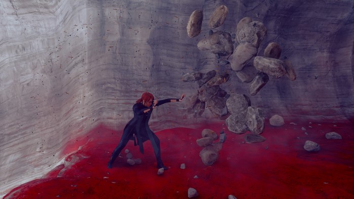 Jesse Faden from Control levitates rocks in a cave