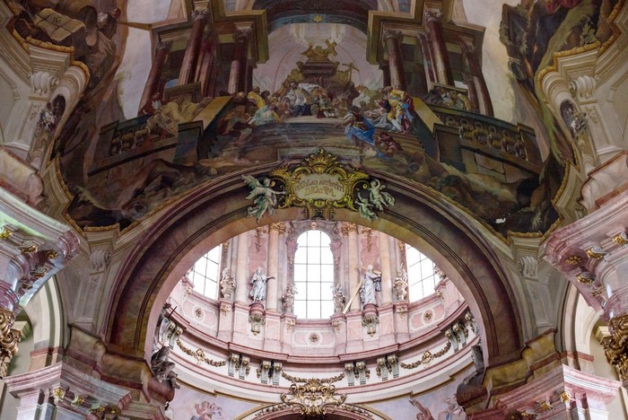 Interior of a grand cathedral with frescoes and statues