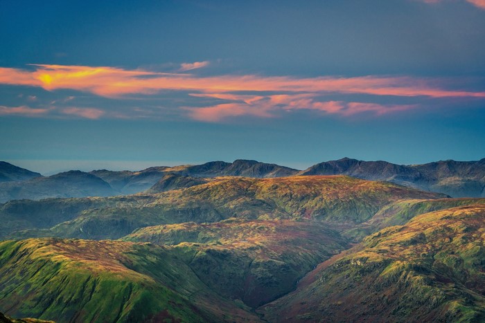 Mountain range with colorful clouds at sunset