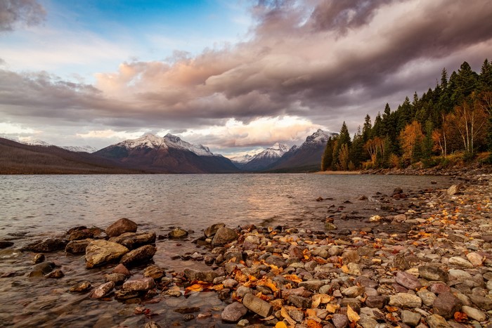 Lake and mountains with snow and autumn trees