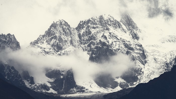 Snow-covered mountains shrouded in clouds