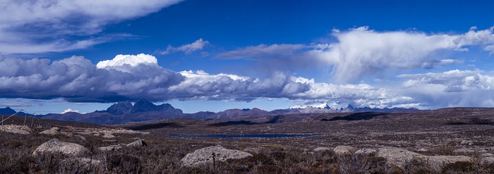 Panoramic view of a mountainous landscape with clouds