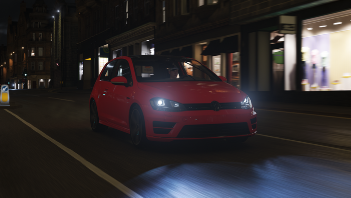 Red Volkswagen Golf R driving at night in Forza Horizon 4