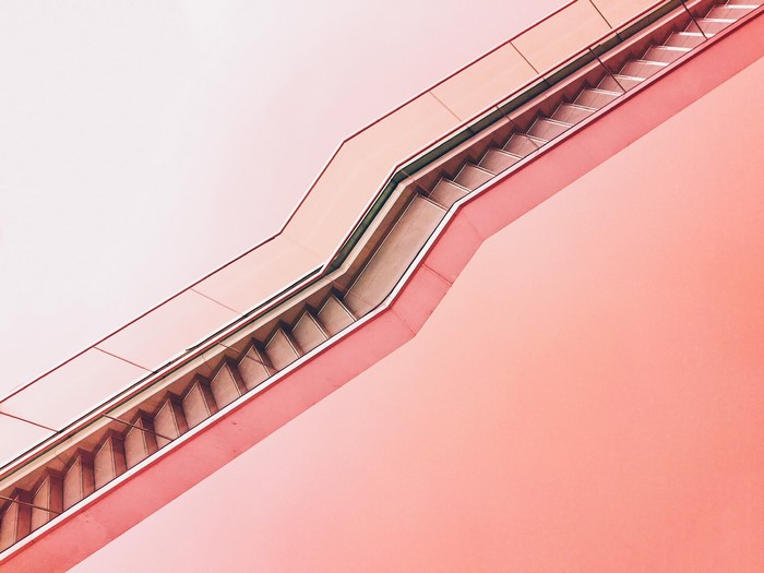 Pink Escalator Against a Light Pink Background