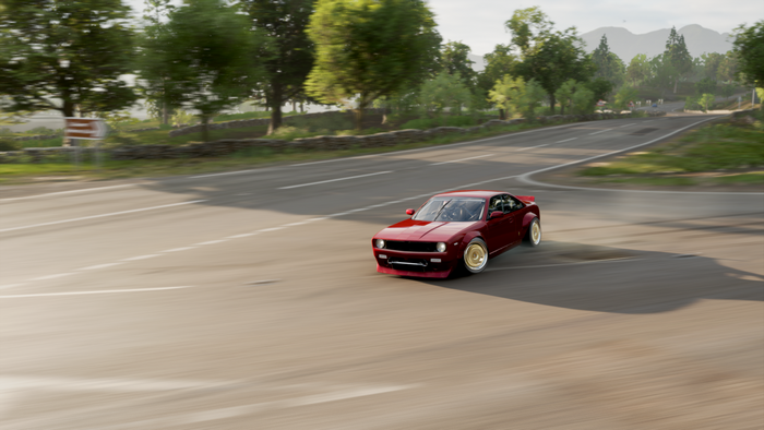 Red car drifting on a road in Forza Horizon 4
