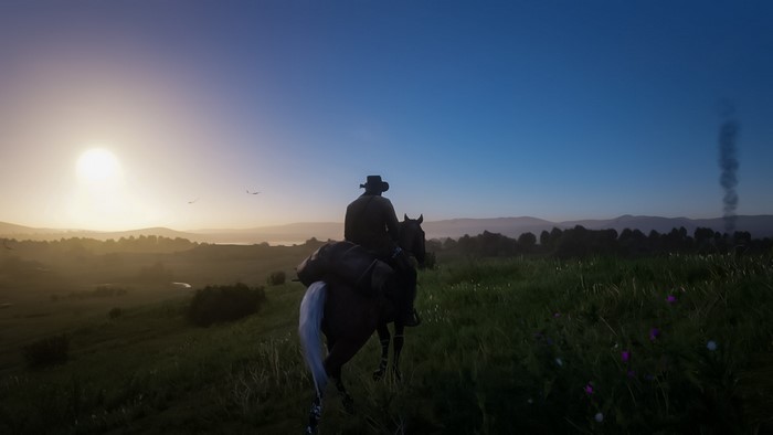 Arthur Morgan from Red Dead Redemption 2 on horseback at sunrise