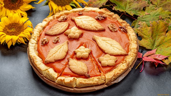 Pumpkin pie with autumn leaves and sunflowers