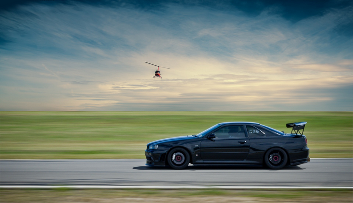 Black Nissan Skyline R34 GT-R with Helicopter