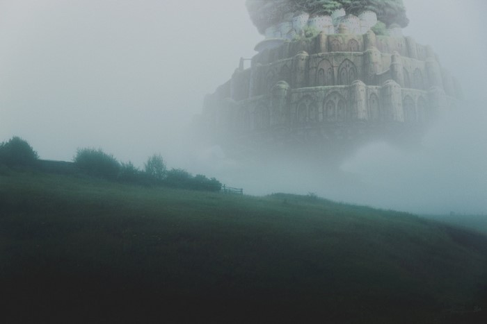 Floating castle in the mist over a field