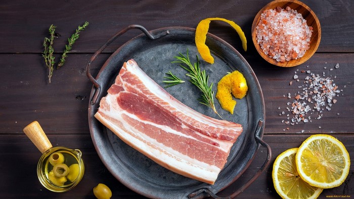 Raw pork belly with herbs, lemon, olives, and salt