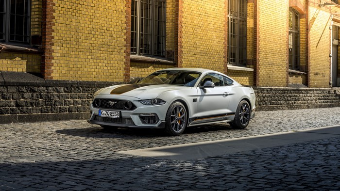 White Ford Mustang Mach 1 on cobblestone street