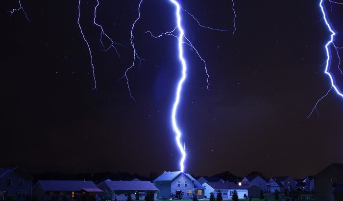 Lightning striking a house at night