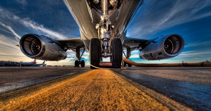 Airplane engines and landing gear on tarmac