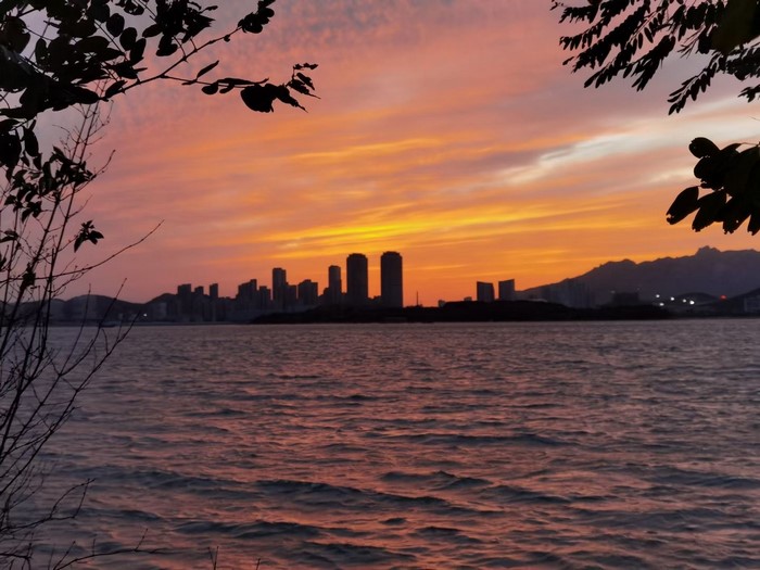 City skyline at sunset over water