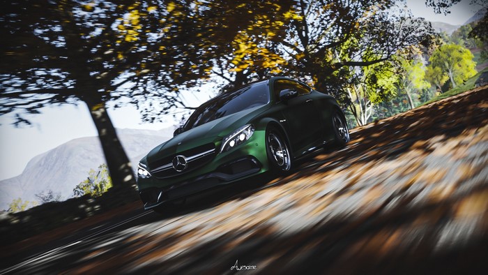 Green Mercedes-Benz C63 AMG driving on a road