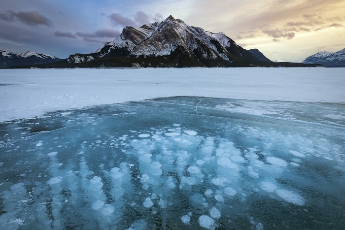 Frozen Lake with Bubbles and Mountains in Canada