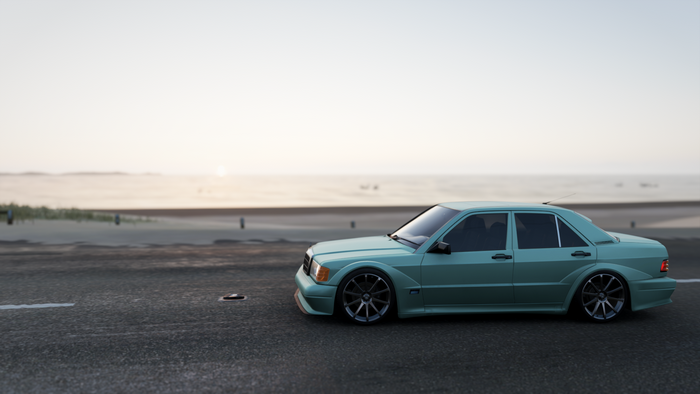 Turquoise Mercedes-Benz 190E on asphalt road by the sea