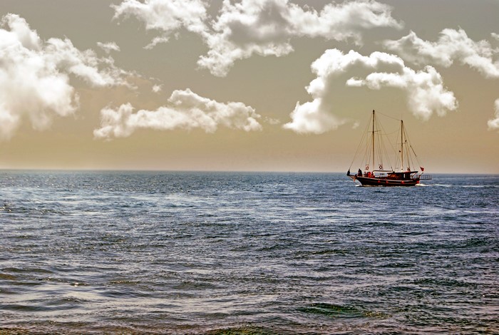 Sailboat on the sea with clouds