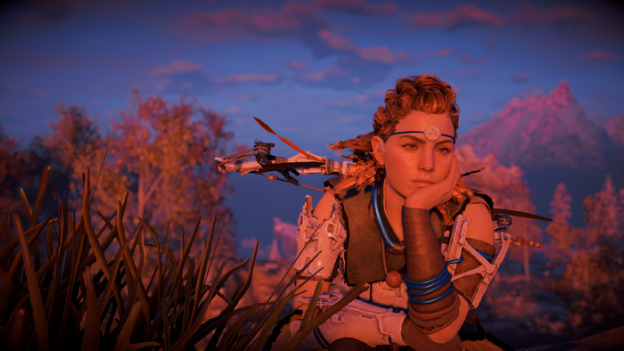 Aloy from Horizon Zero Dawn sitting at sunset