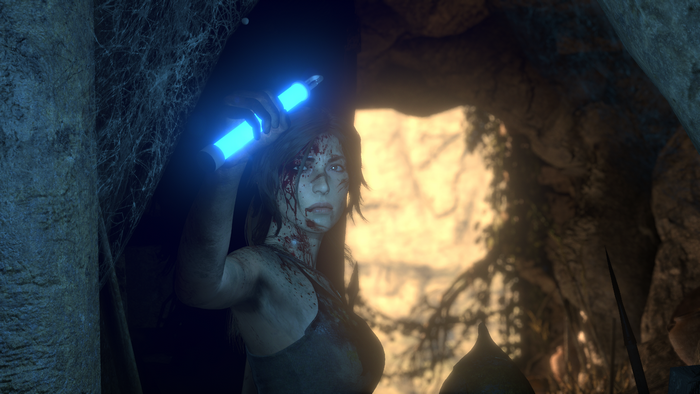 Lara Croft from Rise of the Tomb Raider holding a blue light