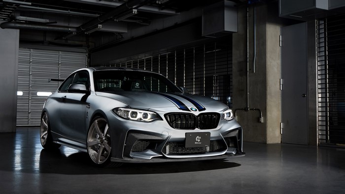 Silver BMW M2 with Blue Stripes in Garage
