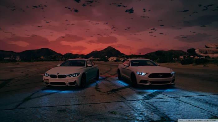 White BMW and Mustang cars at sunset