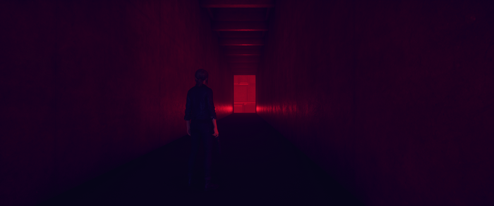 Jesse Faden from Control in a red hallway