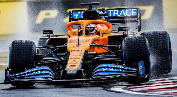 Carlos Sainz Jr. McLaren F1 car racing in the wet
