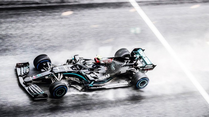Valtteri Bottas driving a Mercedes F1 car in the rain