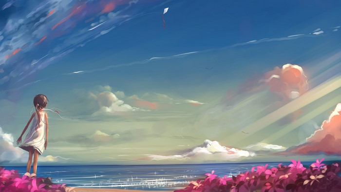 Girl watching a kite fly over the ocean