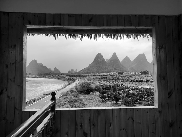 Monochrome landscape with mountains viewed through a window