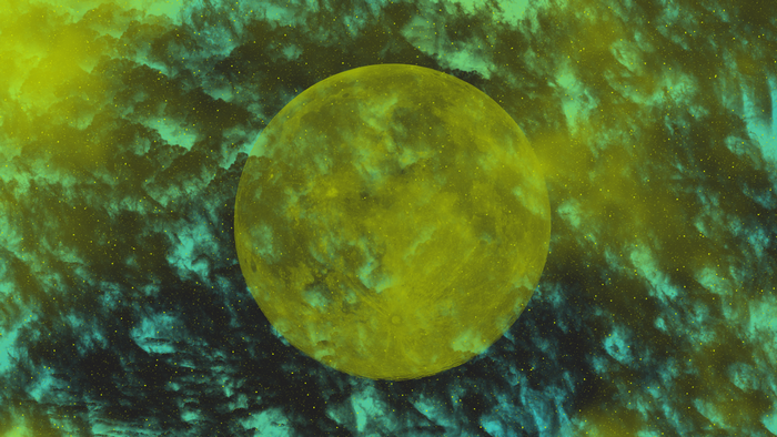 Yellow moon in a starry, cloudy space